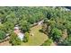 An aerial view of a home with garage, shed, and lush landscaping nestled in a forest setting at 6992 Sherrills Ford Rd, Sherrills Ford, NC 28673