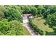 A charming single-Gathering home with an attached two-car garage sits nestled among lush trees on a sprawling green lawn at 6992 Sherrills Ford Rd, Sherrills Ford, NC 28673