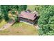 The backyard boasts a covered porch and lush greenery, complete with a rock drainage system at 6992 Sherrills Ford Rd, Sherrills Ford, NC 28673