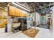 The basement laundry room features a utility sink, washer, dryer, shelving, and an exterior door at 6992 Sherrills Ford Rd, Sherrills Ford, NC 28673