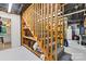 The carpeted basement staircase has a light wood railing and convenient built-in storage for wine and other items at 6992 Sherrills Ford Rd, Sherrills Ford, NC 28673