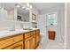Bright bathroom with double sink vanity, patterned wallpaper, and natural light from a window at 6992 Sherrills Ford Rd, Sherrills Ford, NC 28673