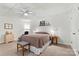 This bedroom features a ceiling fan, carpet flooring, and simple furniture; ideal for relaxation and sleep at 6992 Sherrills Ford Rd, Sherrills Ford, NC 28673