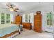 Bright bedroom featuring wood furniture, natural light, and serene views of the surrounding greenery from the windows at 6992 Sherrills Ford Rd, Sherrills Ford, NC 28673