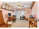 Cozy bedroom with ceiling fan, carpet, and shelves displaying dolls and decorative items at 6992 Sherrills Ford Rd, Sherrills Ford, NC 28673