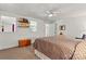The bedroom features neutral colors, a ceiling fan, carpet flooring, and a window above the bed at 6992 Sherrills Ford Rd, Sherrills Ford, NC 28673