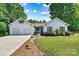 Charming single-Gathering home with a two-car garage, pristine lawn, mature trees, and lovely landscaping at 6992 Sherrills Ford Rd, Sherrills Ford, NC 28673