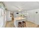 This cozy kitchen features bright white cabinets, appliances, an island with bar seating, and wood-look flooring at 6992 Sherrills Ford Rd, Sherrills Ford, NC 28673