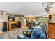 Inviting living room featuring a fireplace, hardwood floors, and a cozy seating area with an open kitchen at 6992 Sherrills Ford Rd, Sherrills Ford, NC 28673