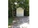 Exterior shot of the outbuilding in a wooded area and gravel driveway at 6992 Sherrills Ford Rd, Sherrills Ford, NC 28673
