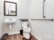 This bathroom features a floating sink and grab bars for safety and accessibility at 720 Herlong S Ave, Rock Hill, SC 29732