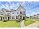 Charming white two-story townhome featuring a welcoming front porch and beautifully landscaped front yard at 720 Herlong S Ave, Rock Hill, SC 29732