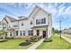 Charming white two-story townhome featuring a welcoming front porch and beautifully landscaped front yard at 720 Herlong S Ave, Rock Hill, SC 29732