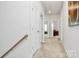 Upstairs hallway leading to bedrooms, showing carpeted floors, doors and wall art at 720 Herlong S Ave, Rock Hill, SC 29732