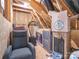 Large attic space used for storage, containing boxes, furniture, and water heater at 805 Old Little Rock Rd, Charlotte, NC 28214