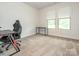 Bright bedroom with plush carpet, neutral walls, and ample natural light, creating a comfortable and versatile space at 805 Old Little Rock Rd, Charlotte, NC 28214