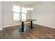 Bright dining room with wood floors, modern lighting, and windows, providing a welcoming space for meals at 805 Old Little Rock Rd, Charlotte, NC 28214