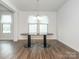 Open dining area featuring modern light fixture, neutral walls, and hardwood flooring, perfect for entertaining guests at 805 Old Little Rock Rd, Charlotte, NC 28214
