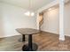 Dining room featuring modern lighting, an elegant table, and a hardwood floor, complemented by neutral walls at 805 Old Little Rock Rd, Charlotte, NC 28214