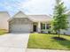 Charming one-story home featuring a stone facade, attached garage, and a well-manicured lawn and landscaping at 805 Old Little Rock Rd, Charlotte, NC 28214
