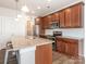 Kitchen island with stools and granite counters, stainless steel appliances at 805 Old Little Rock Rd, Charlotte, NC 28214