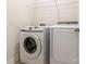 Functional laundry room with modern Samsung washer and dryer and wire rack shelving above at 805 Old Little Rock Rd, Charlotte, NC 28214
