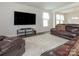 Spacious living room with leather seating, a large television, and plush carpeting, perfect for relaxing and entertaining at 805 Old Little Rock Rd, Charlotte, NC 28214