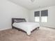 Relaxing primary bedroom with soft carpet, neutral walls, and cozy bed, creating a peaceful retreat at 805 Old Little Rock Rd, Charlotte, NC 28214