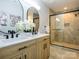 Bathroom featuring double vanity, modern mirrors, and glass shower with tile surround at 8611 Earthenware Dr, Charlotte, NC 28269