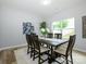 Charming dining room featuring wainscoting, modern light fixture and hardwood floors at 8611 Earthenware Dr, Charlotte, NC 28269