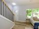 Welcoming foyer showcasing wood-look floors, stairway access, and natural lighting at 8611 Earthenware Dr, Charlotte, NC 28269