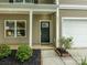 Covered front porch with a storm door, and manicured landscaping at 8611 Earthenware Dr, Charlotte, NC 28269