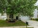 Charming home featuring a well-manicured lawn, mature landscaping, and a classic two-car garage at 8611 Earthenware Dr, Charlotte, NC 28269