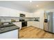 Stylish kitchen with stainless appliances, white cabinetry and sleek countertops at 8611 Earthenware Dr, Charlotte, NC 28269