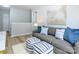 Comfortable living room showcasing a modern couch, decorative pillows, and wood-look flooring at 8611 Earthenware Dr, Charlotte, NC 28269