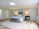 Bright and airy bedroom boasts a large bed, neutral decor, and wood-look floors for a serene retreat at 8611 Earthenware Dr, Charlotte, NC 28269