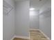 Spacious walk-in closet with wood-look flooring and wire shelving at 8611 Earthenware Dr, Charlotte, NC 28269