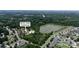 An aerial view of the Seven Oaks Clubhouse, pool, and lake in a residential neighborhood in Charlotte, NC at 10211 Snowbell Ct, Charlotte, NC 28215