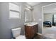 Bathroom featuring a single sink vanity, updated mirror and lighting, with grey walls at 10211 Snowbell Ct, Charlotte, NC 28215