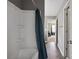 Bathroom featuring a shower tub combination and a hallway leading into another bedroom at 10211 Snowbell Ct, Charlotte, NC 28215