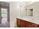 Bathroom with a double vanity, sleek mirrors, and an open doorway that leads to the bedroom, providing modern convenience at 10211 Snowbell Ct, Charlotte, NC 28215