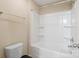 Bright bathroom featuring a clean white tub, shower, and toilet creating a simple, yet functional, and inviting space at 10211 Snowbell Ct, Charlotte, NC 28215