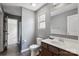 A simple bathroom includes a toilet, vanity sink, and shower/bath combo at 10211 Snowbell Ct, Charlotte, NC 28215