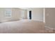 Bright and airy bedroom with carpeted floors and two windows, plus a door at 10211 Snowbell Ct, Charlotte, NC 28215