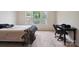 Bedroom featuring three windows offering views of the lush outdoors, complemented by a cozy bed and functional desk space at 10211 Snowbell Ct, Charlotte, NC 28215