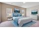 Staged primary bedroom features a comfortable bed, nightstands, dresser, and scenic artwork at 10211 Snowbell Ct, Charlotte, NC 28215