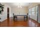 Formal dining room featuring wainscoting, chandelier, and ample natural light at 10211 Snowbell Ct, Charlotte, NC 28215