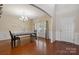 Bright dining room with hardwood floors, wainscoting, a chandelier, and natural light from large windows at 10211 Snowbell Ct, Charlotte, NC 28215