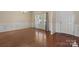 Bright dining room with hardwood floors, wainscoting, and natural light from large windows at 10211 Snowbell Ct, Charlotte, NC 28215