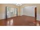 Bright, staged dining room with hardwood floors, wainscoting, and natural light from large windows at 10211 Snowbell Ct, Charlotte, NC 28215